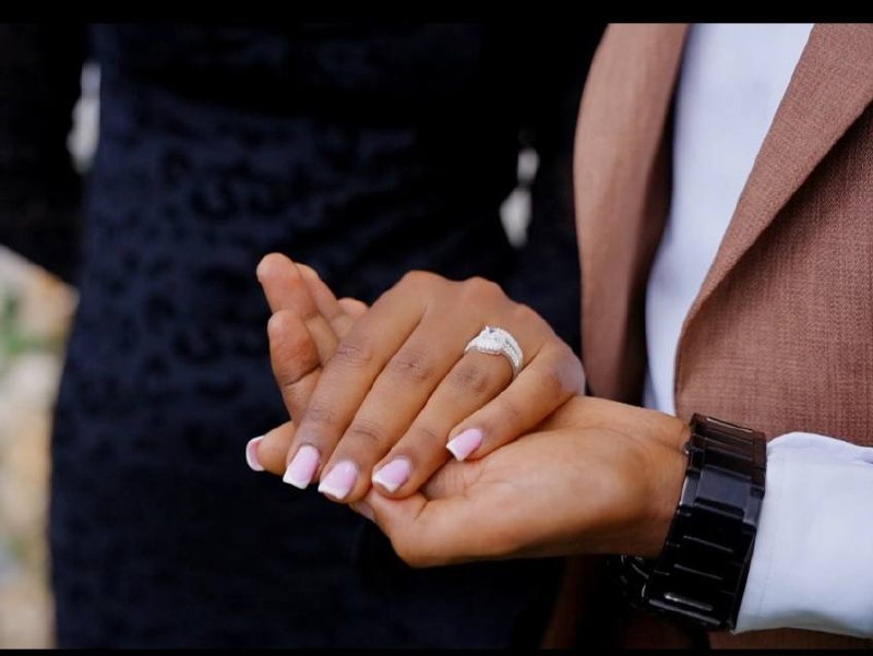 The couple holding hands